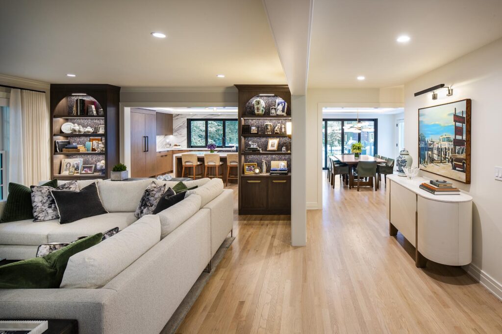 Open layout showing living room, kitchen, dining area, and hallway with modern design