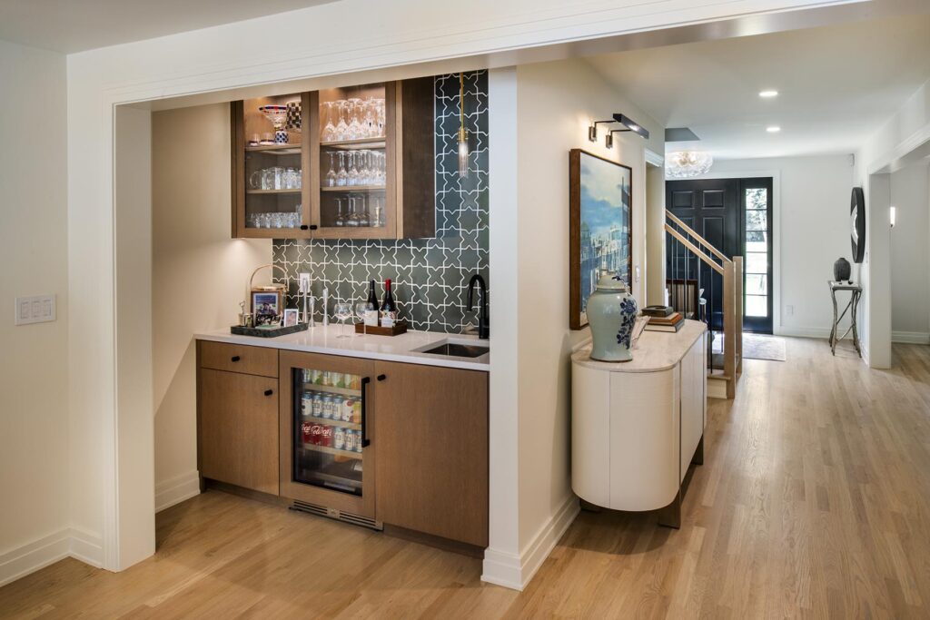 Stylish mini bar and beverage nook with countertop, shelving, and drink essentials