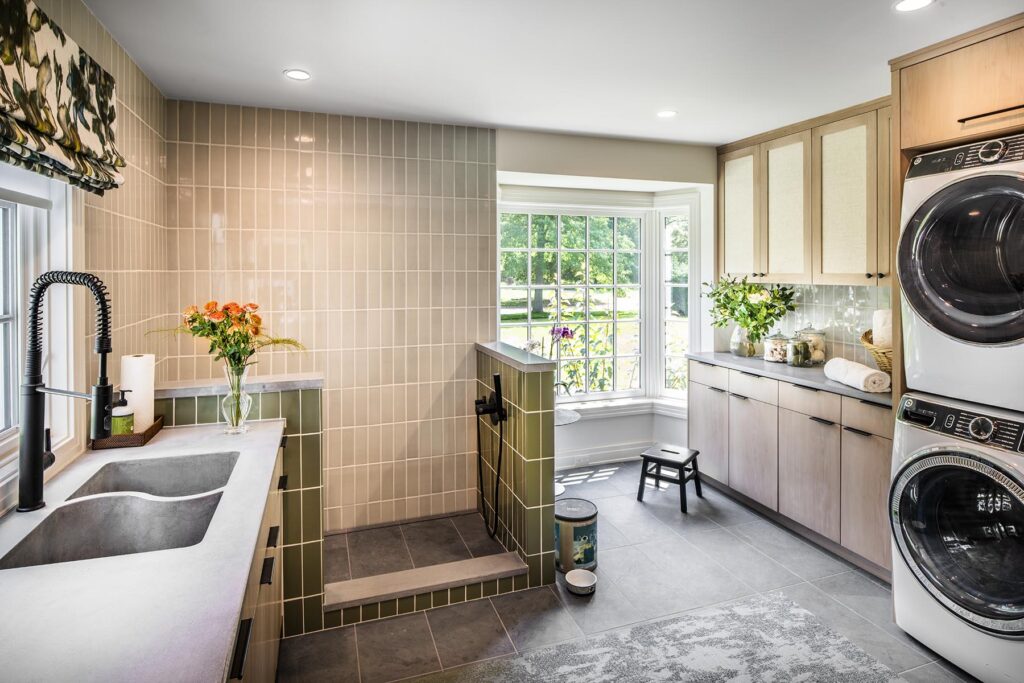 Bright laundry room with windows, washer and dryer, and a walk-in pet shower