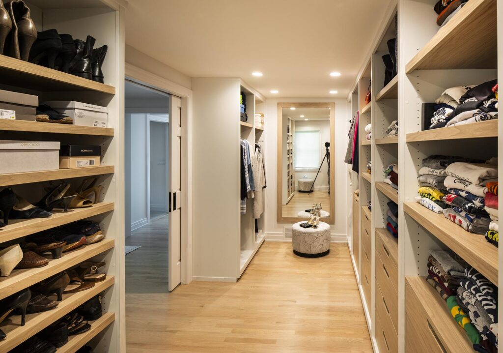 Luxury walk-in closet with ample storage and built-in cabinetry