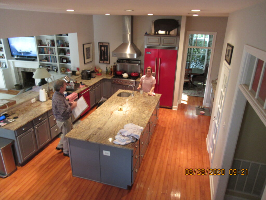 Before remodel – traditional Leesburg kitchen with granite countertops, red appliances, and wood floors in a Hunt Country home