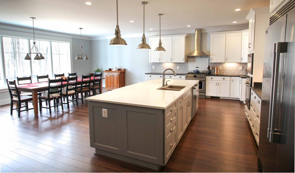 Open-concept kitchen and breakfast area with energy-efficient appliances in a Net Zero custom home by Alair Homes Hunt Country
