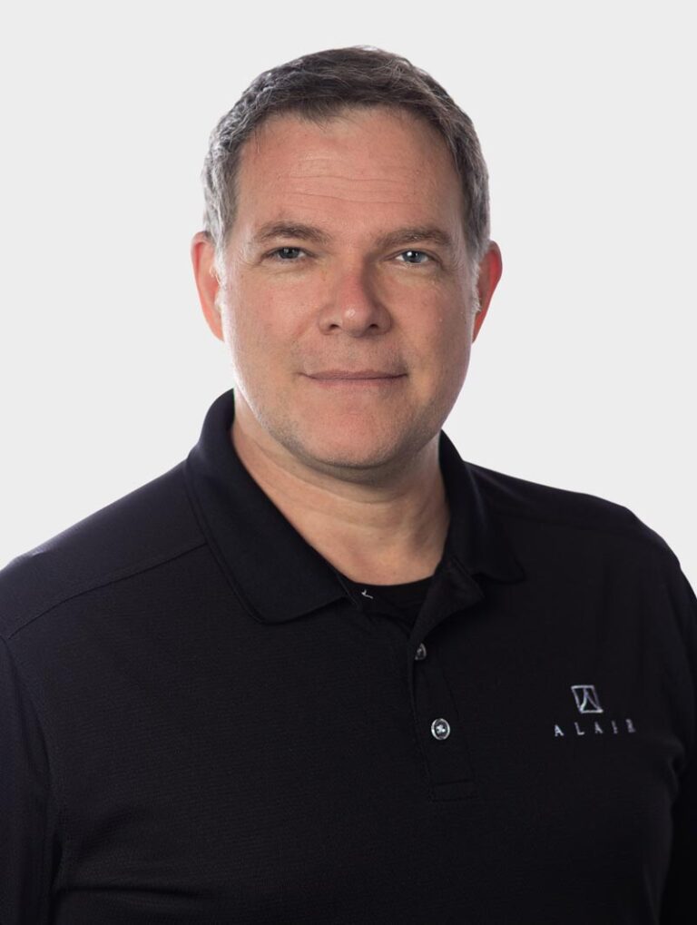 Robert Kerr, Director of Procurement at Alair Homes, Wearing an Alair Homes shirt against pewter background.