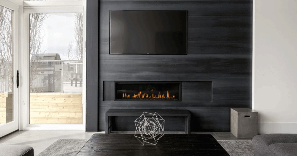modern living room with large windows and textured black feature wall with modern fireplace inset