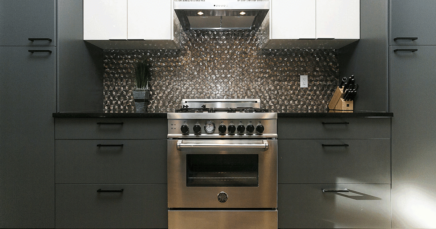 Custom kitchen dark grey lower cabinets interesting metallic backsplash stainless steel oven and white cabinets