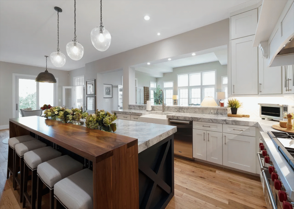 classic white cabinetry and polished countertops contrasted by a bold island wrapped in reclaimed wood