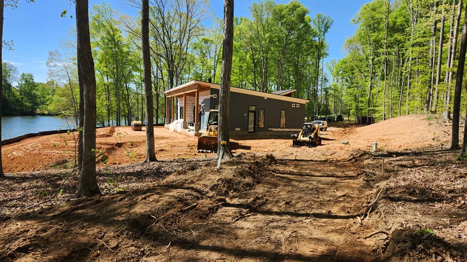 Custom home site preparation in wooded area of lakefront custom home