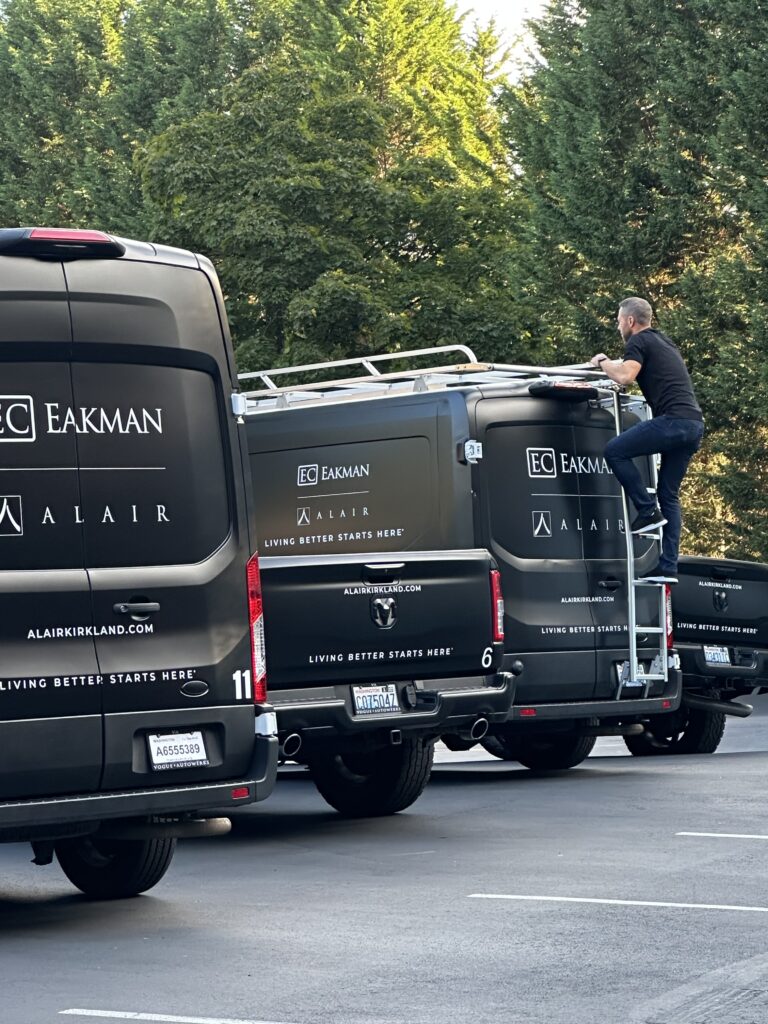 Stacy Eakman climbing the ladder on one of the Alair Homes vans