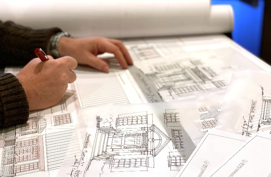 Architect reviewing custom home floorplans with a family in Northern Virginia