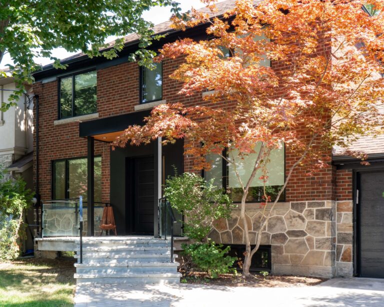 Red brick home accented with black soffits and windows