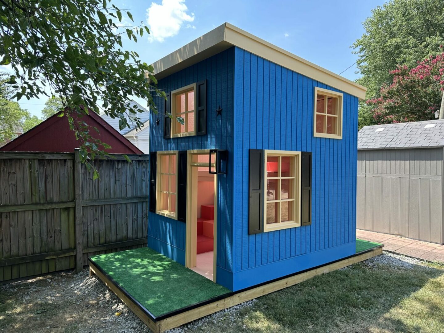 Custom-built wooden playhouse designed and constructed by Alair Alexandria