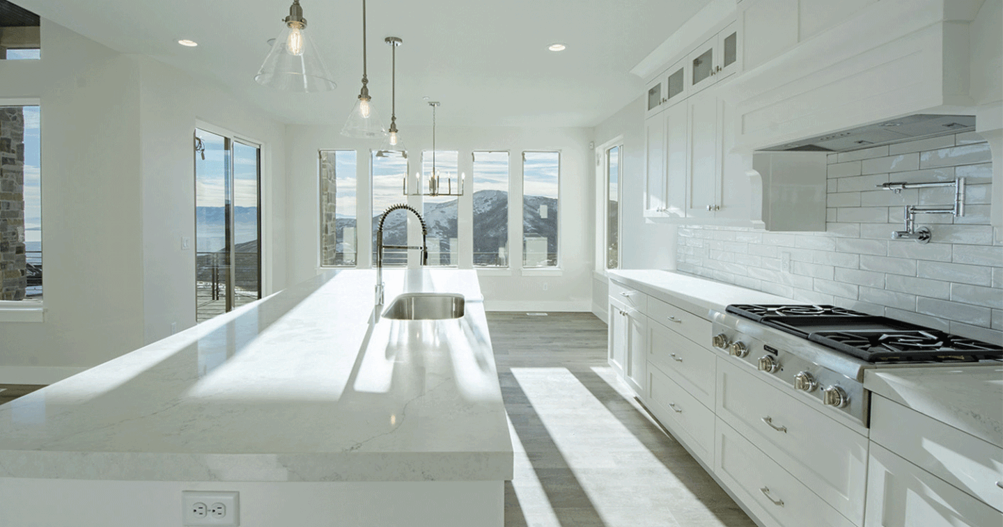 custom all white kitchen surrounded by windows