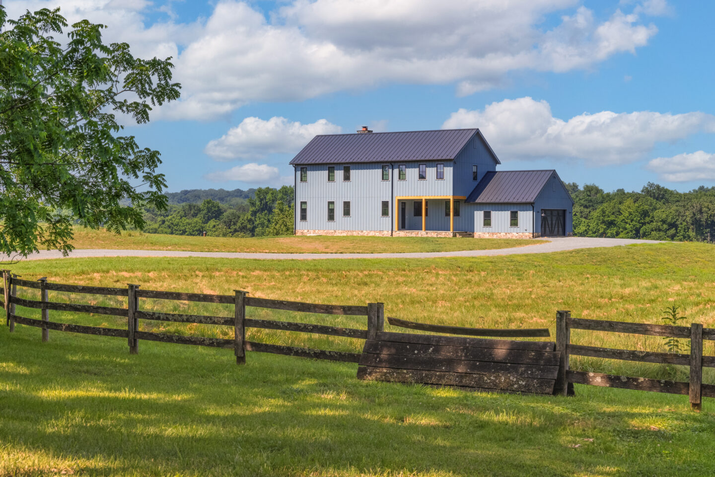 Custom two-story farmhouse in Loudoun County built by Alair Homes Hunt Country for first-time homeowners, featuring modern design and countryside views.