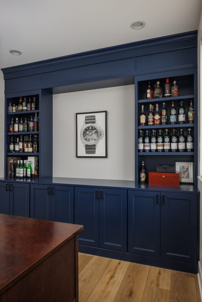Custom home office with built-in navy cabinetry and shelving, designed by Alair Homes Hunt Country for functional workspace and storage