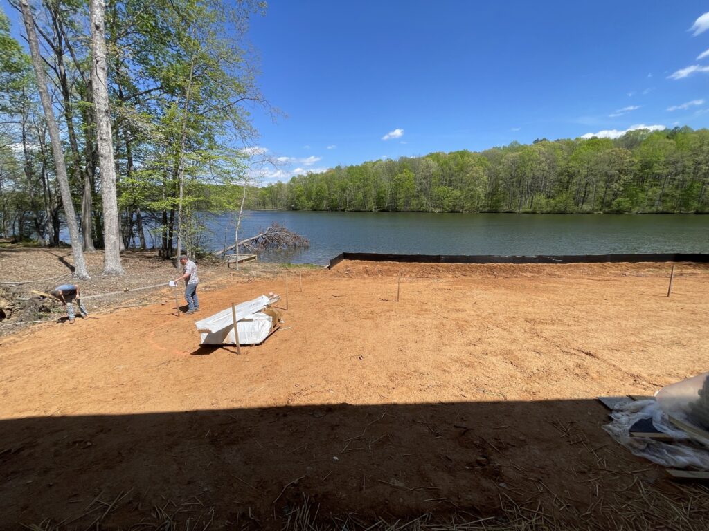 Grading land by the lake for custom home construction in Virginia