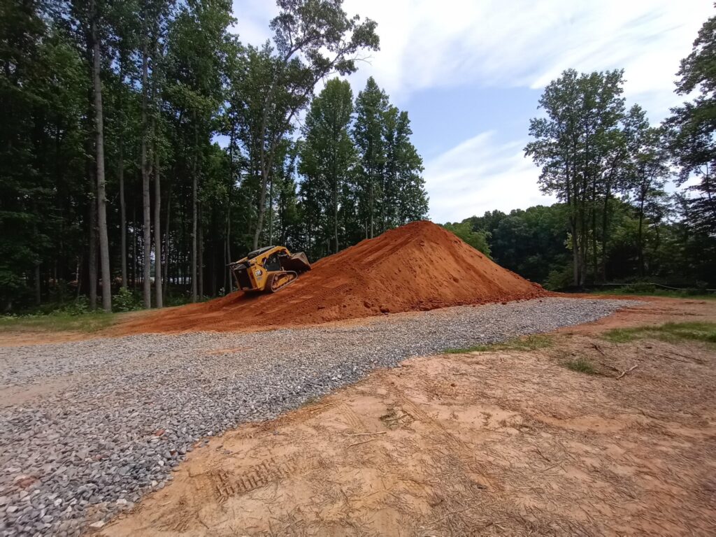 Excavation and site grading to maintain natural surroundings with heavy equipment for custom home build in Lake Anna