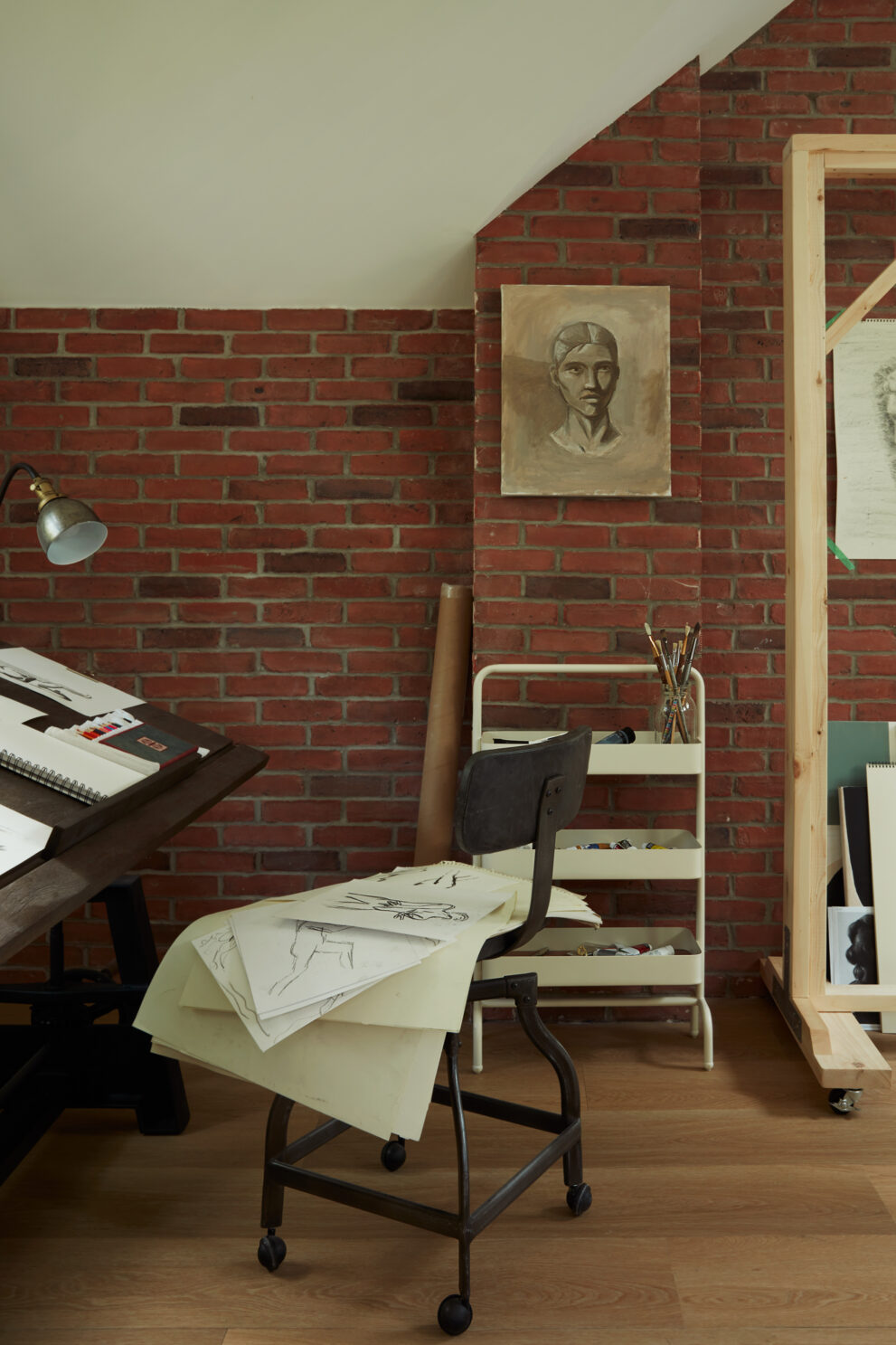An artist's studio with a drawing table