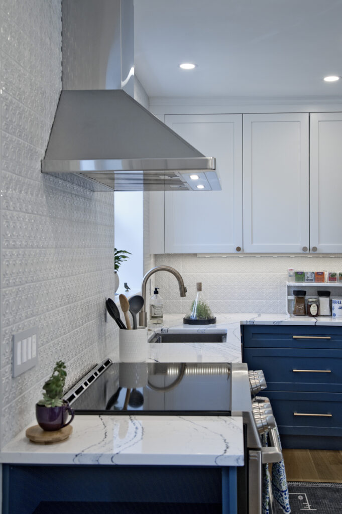Oven hood with white cabinetry in the background.