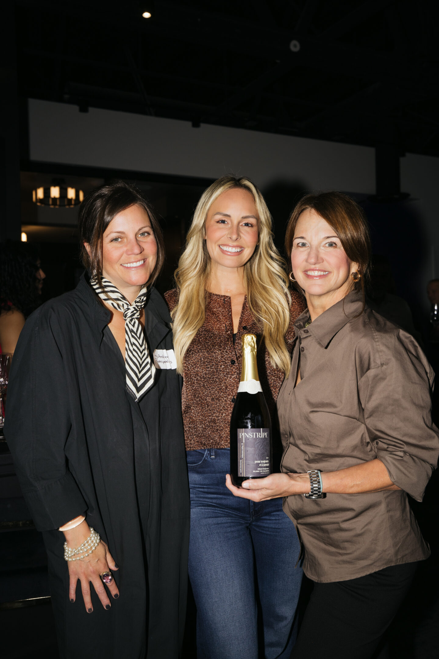 A photo of Amy Andrews of Pinstripe wines and Beth Gale of Alair Homes Kirkland, Pinstripe wines is an official sponsor of Women of Influence Event on November 12