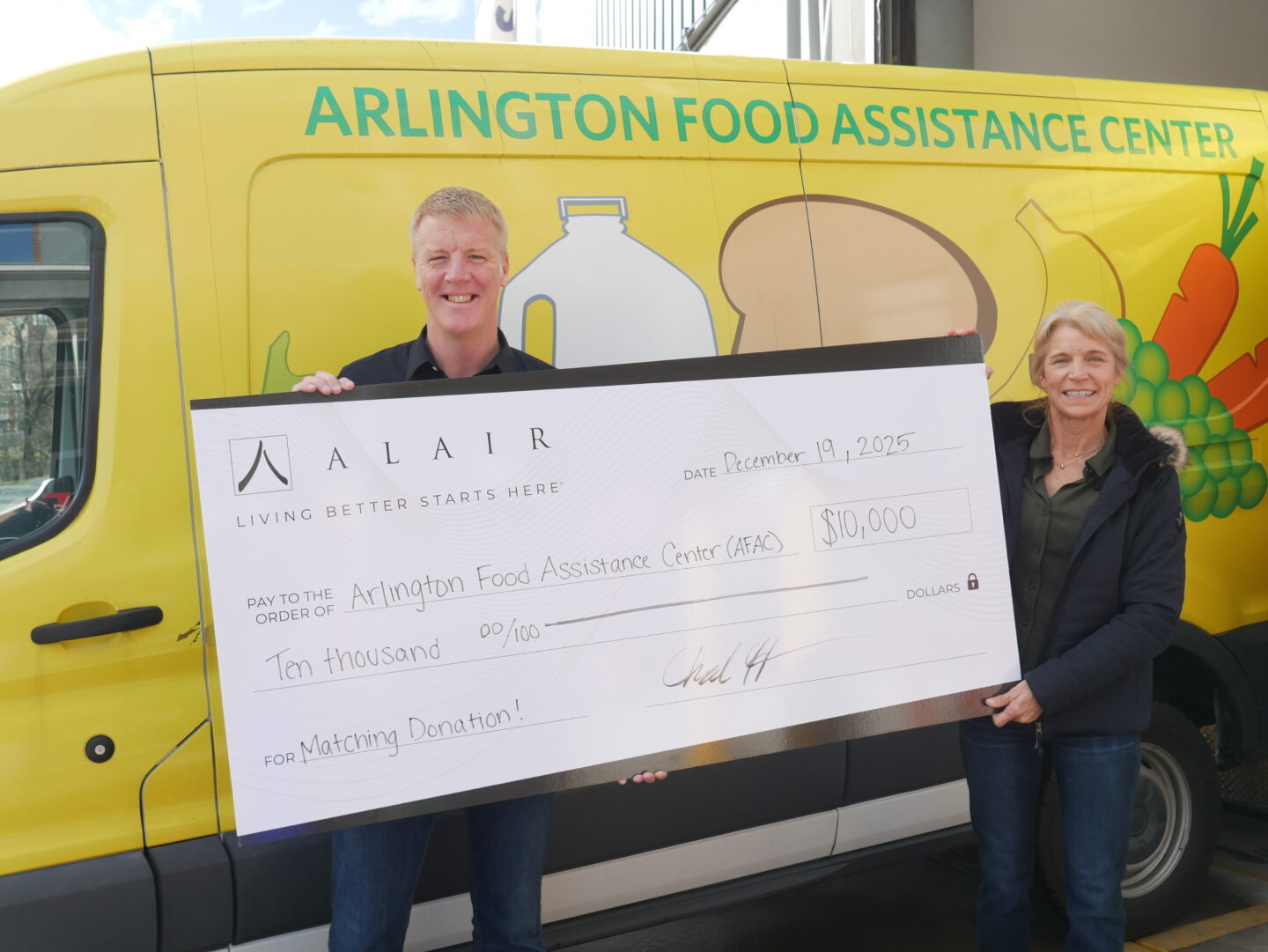 Regional Partner Chad Hackmann with a giant Alair check gifting $10K to AFAC.