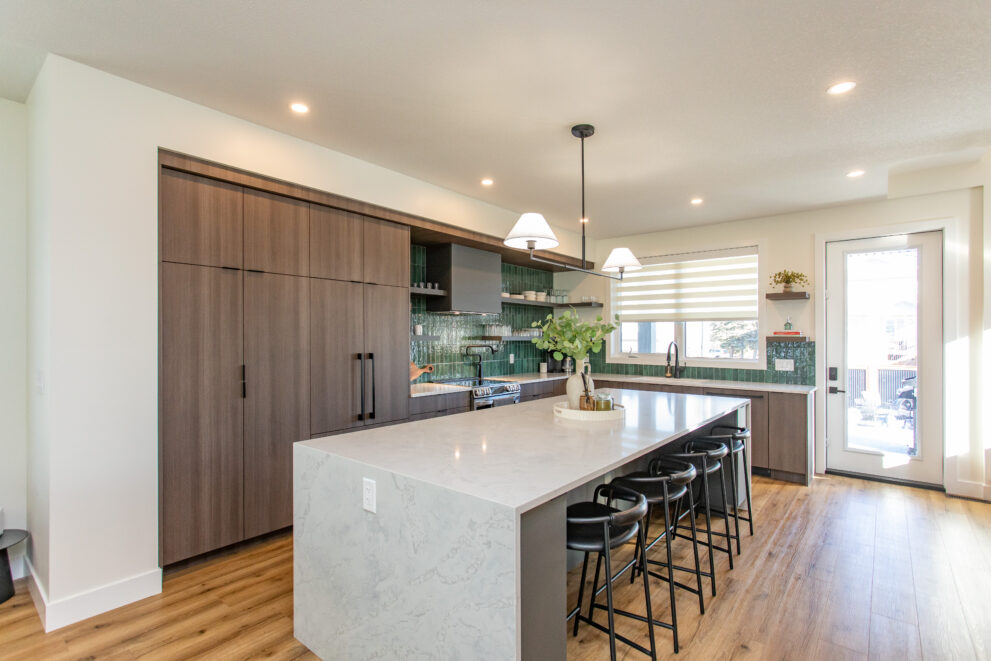 Completed open concept kitchen in custom home by Alair Homes Red Deer showcasing natural light and modern finishes in Central Alberta