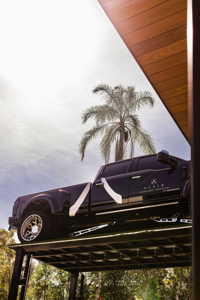 Alair truck parked on a ramp in front of a recently completed American home by Alair in Orlando