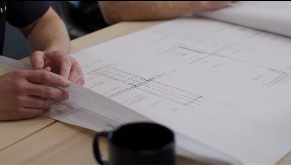 Reviewing structural drawings during custom home planning process with Alair Homes Red Deer in Central Alberta