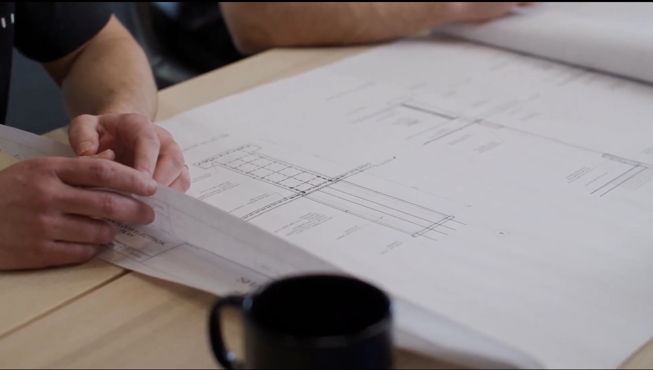 Reviewing structural drawings during custom home planning process with Alair Homes Red Deer in Central Alberta