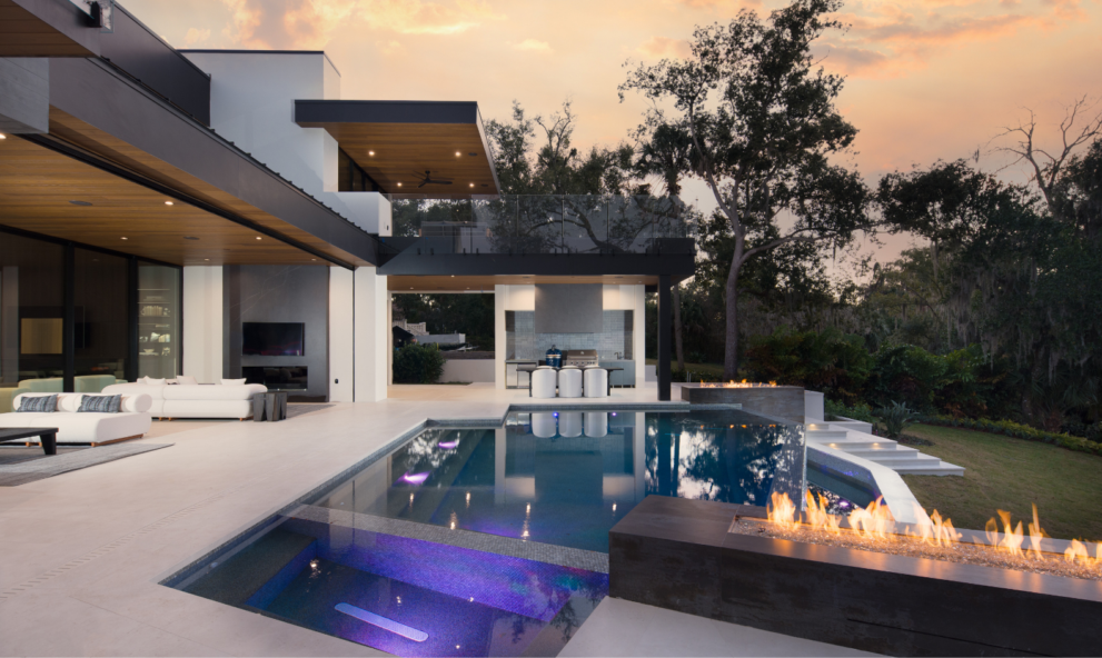 Backyard of The New American Home 2026, with an infinity pool and outdoor fire features
