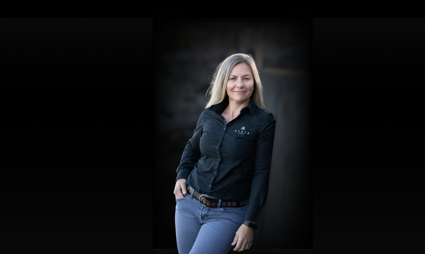 Centered headshot of Chiara Sulyok with dark blur background