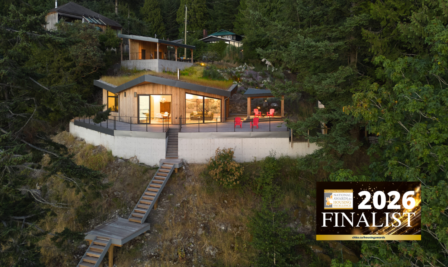 Wide exterior of house with a wide deck built into a steep hill