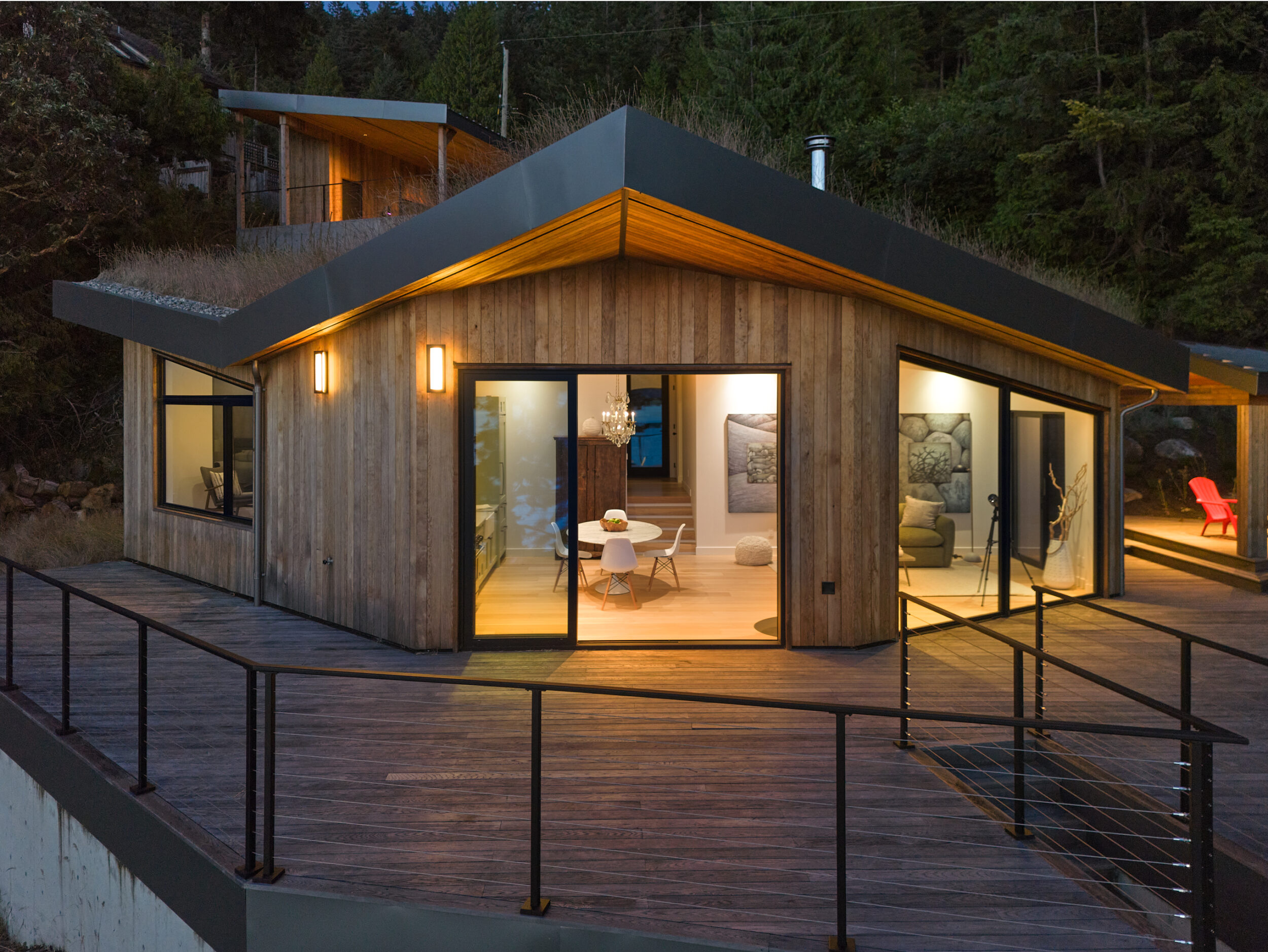 Nighttime exterior of ADU with wide deck