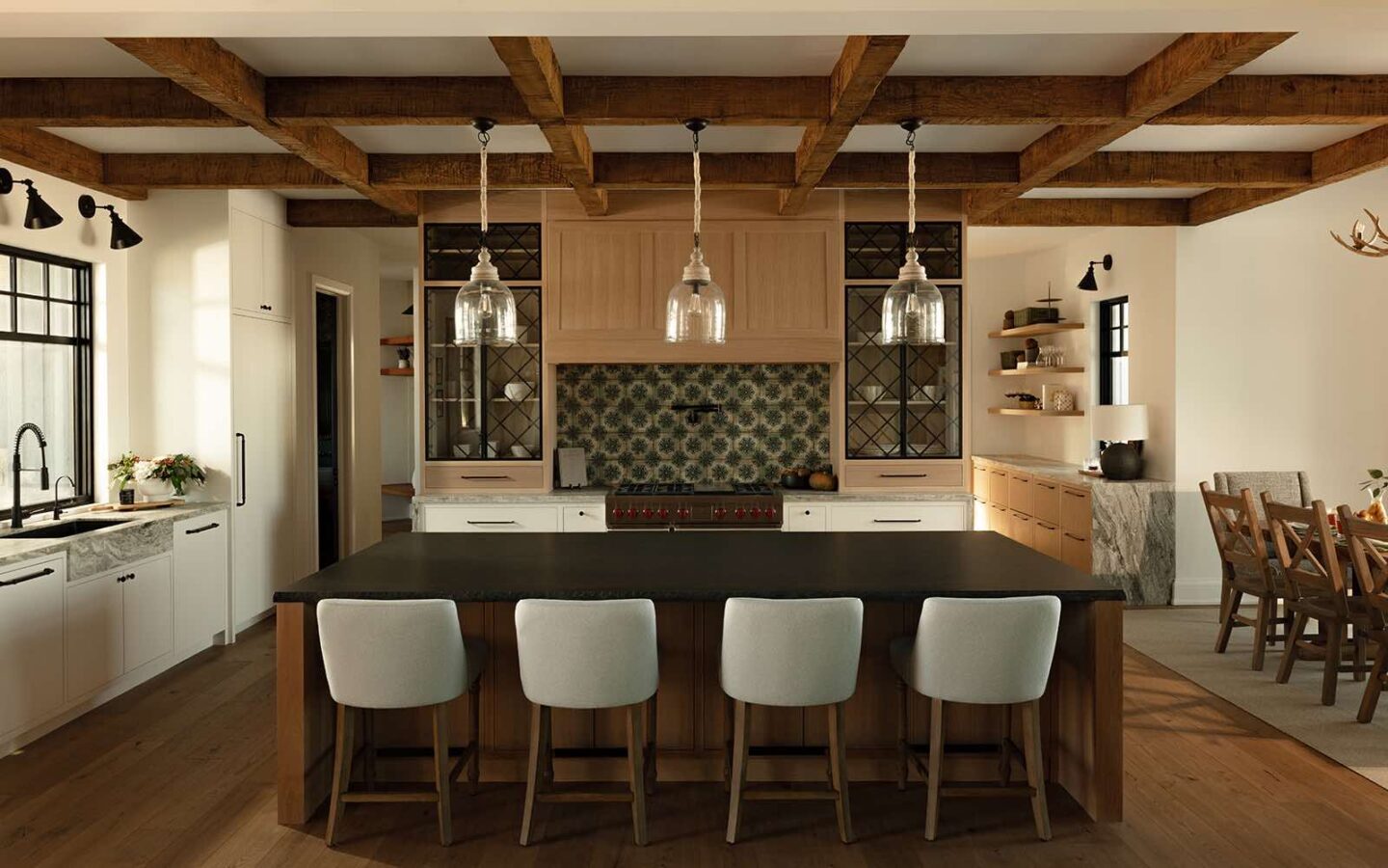 Luxury mountain-modern custom home in Barrie, Ontario featuring exposed timber beams, custom kitchen island, and handcrafted natural finishes