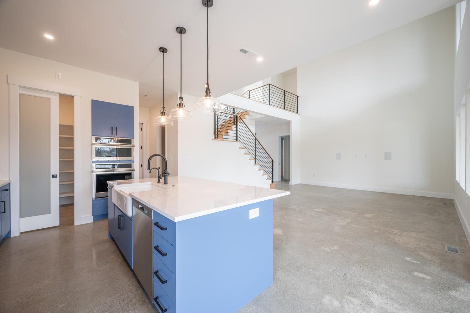 View of concrete floors and blue kitchen island