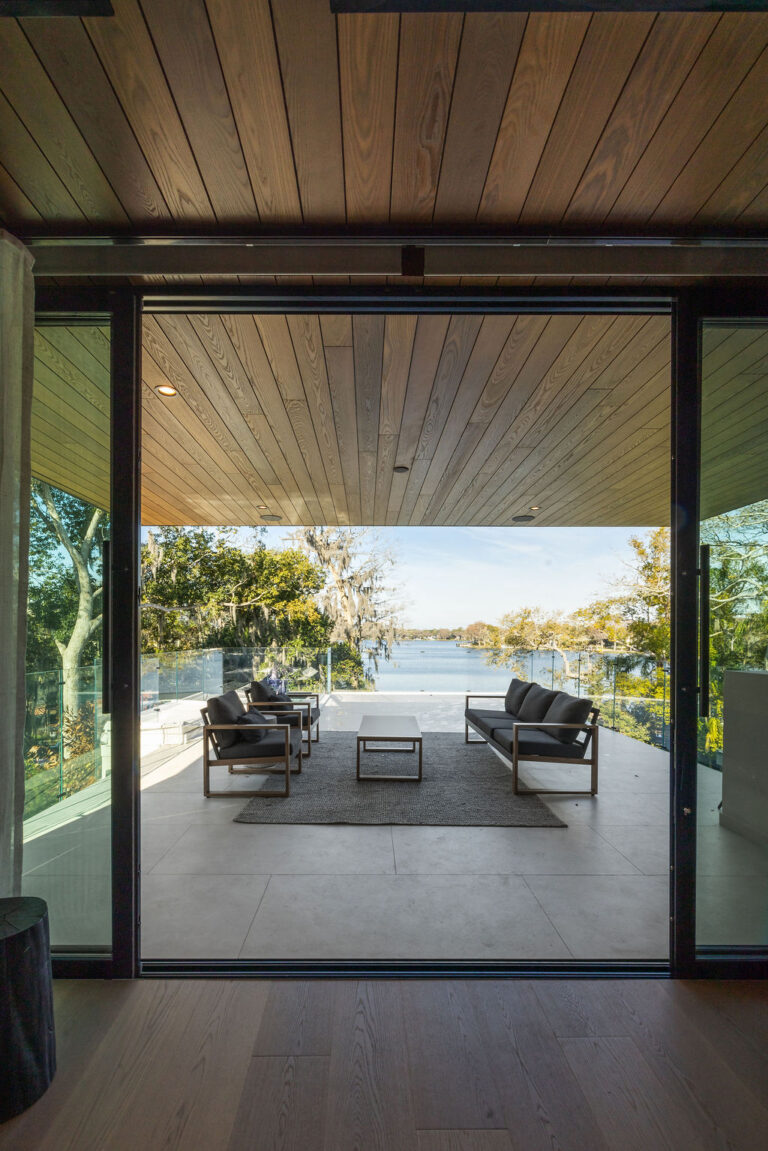 view of the lake from the living room at the new american home in Winter Park, Florida | Alair
