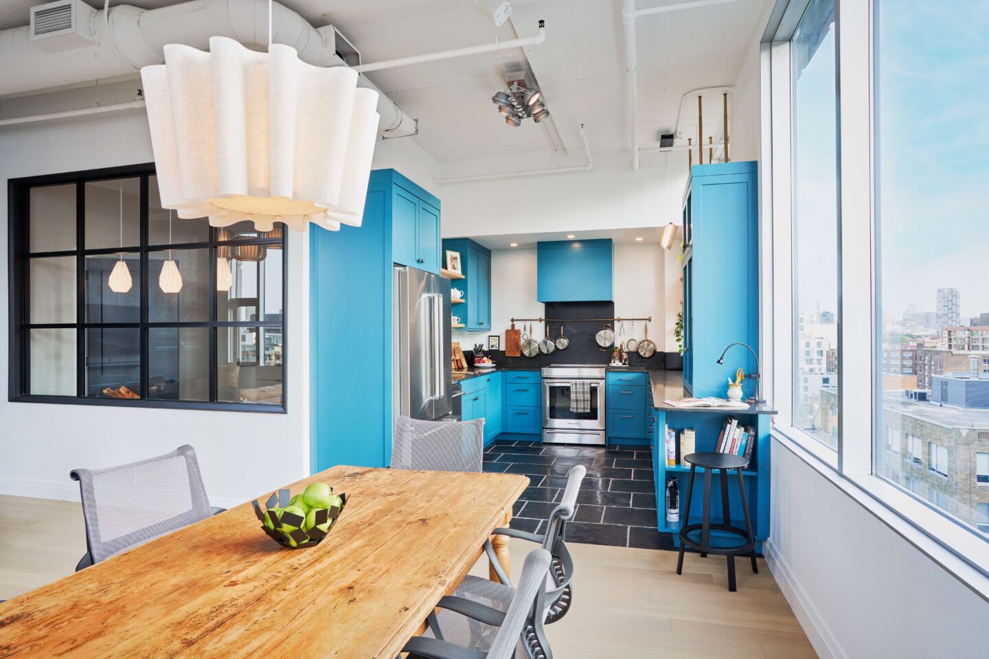 Modern kitchen design featuring blue cabinetry, clean lines, and bright finishes.