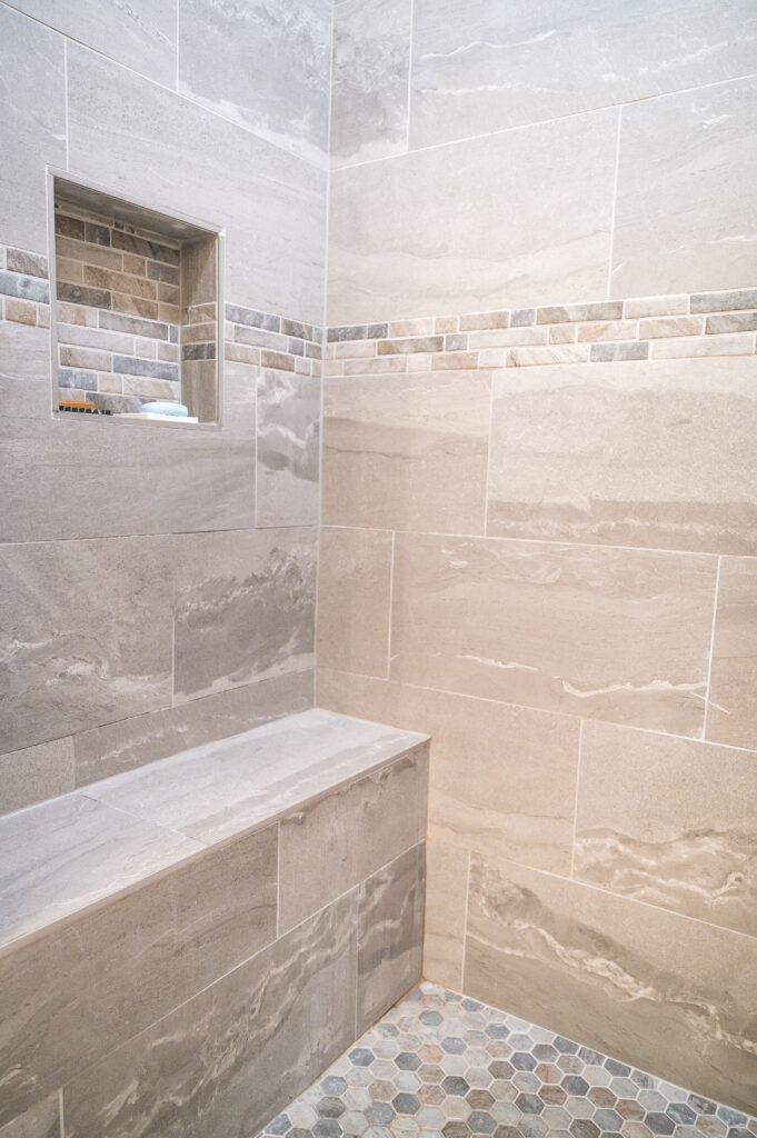 Inside of shower showing bench for accessibility