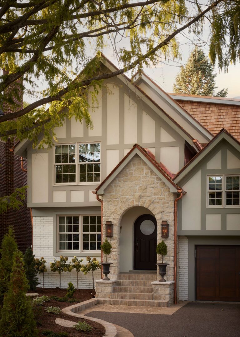 Front exterior of Tudor-style home renovation in Etobicoke with steep gables and heritage-inspired design.