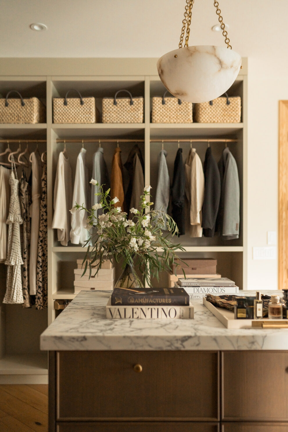walk-in closet design custom closet cabinetry luxury dressing room marble island dresser built-in wardrobe storage modern closet organisation neutral interior design custom millwork closet boutique-style closet high-end home storage solutions