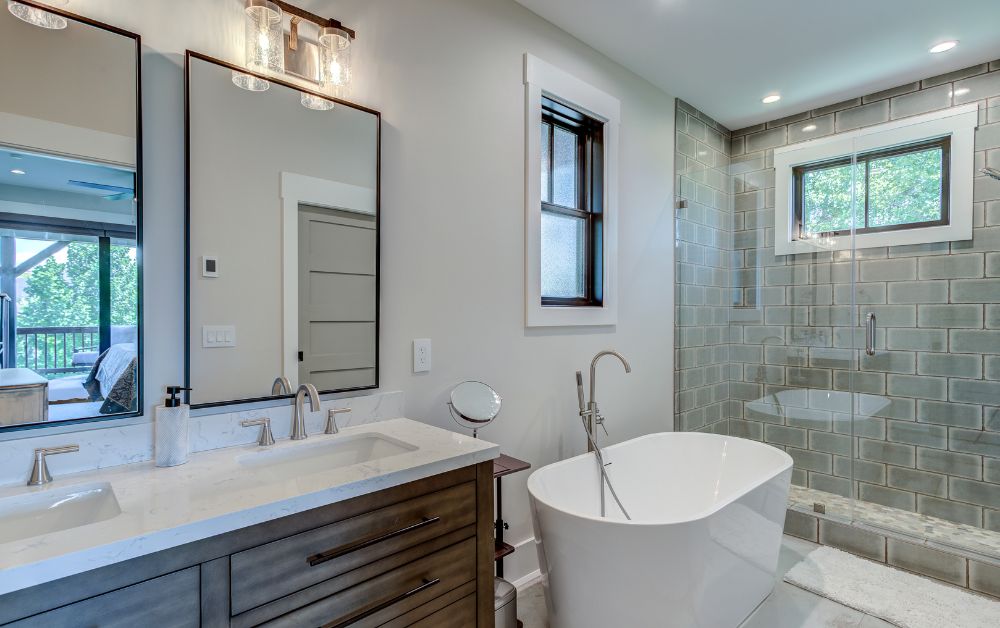 Custom bathroom with a freestanding tub, glass-enclosed tiled shower, double vanity, and elegant finishes in a High Country mountain home.