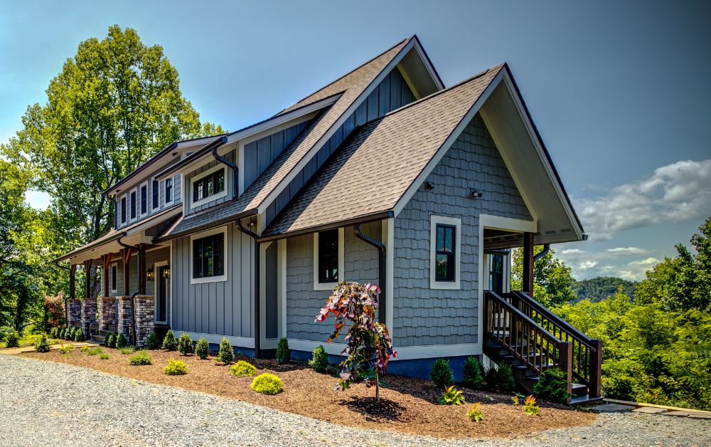 Custom home built by Alair High Country with craftsman-inspired architecture, gray exterior finishes, stone accents, and mountain views in North Carolina's High Country.