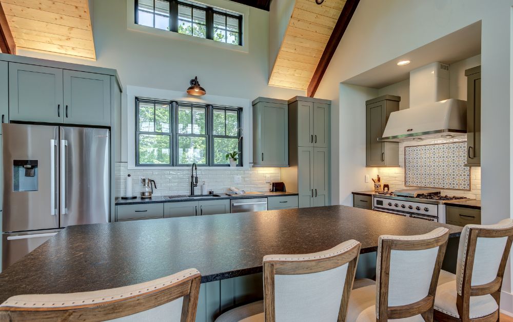Custom kitchen with a large island, vaulted ceilings, and a statement range hood in a modern mountain home.